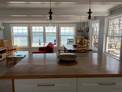 a kitchen with a table and a living room at Chalet chez les Petit in Grandes-Bergeronnes