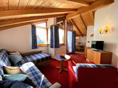 a living room with two couches and a tv at Gatterhof in Riezlern
