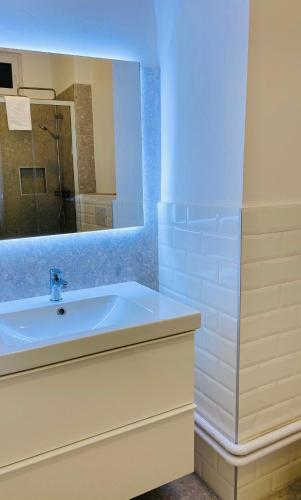 a bathroom with a sink and a mirror at Crops City Stay in Trieste
