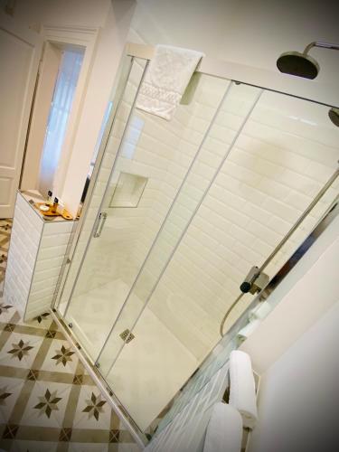 a shower with a glass door in a bathroom at Crops City Stay in Trieste