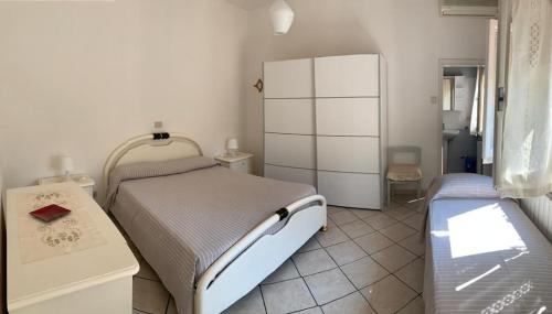 a hospital room with a bed and a refrigerator at La casina dell'Annetta in Lido di Camaiore
