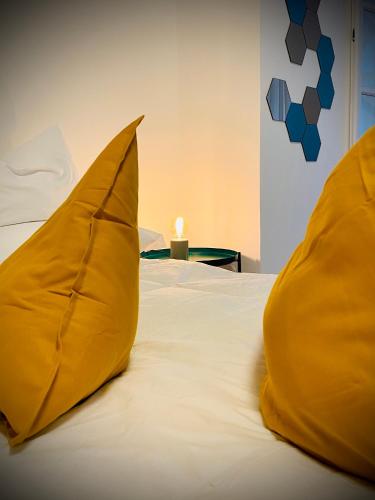 a bed with two yellow pillows on it at Crops City Stay in Trieste