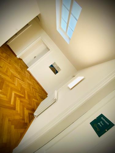 an overhead view of a staircase with a window and wooden floors at Crops City Stay in Trieste