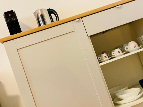 a white kitchen cabinet with a counter top at Crops City Stay in Trieste