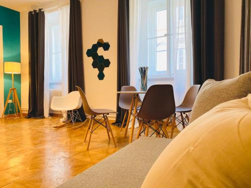 a living room with chairs and a table in it at Crops City Stay in Trieste