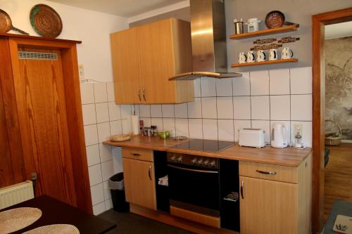 a kitchen with a counter and a stove top oven at Villakunterbunt in Nettetal