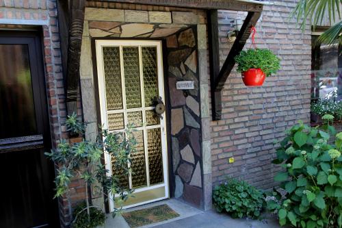 a front door of a brick house with a plant at Villakunterbunt in Nettetal