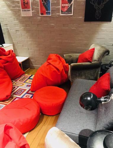 a living room with red pillows and couches at Bell Lodge in Chichester