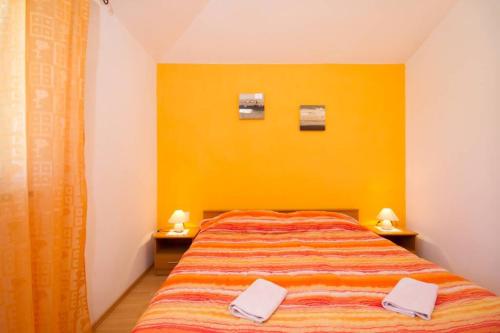 a bedroom with a large bed with a yellow wall at House Antonac in Novigrad Istria
