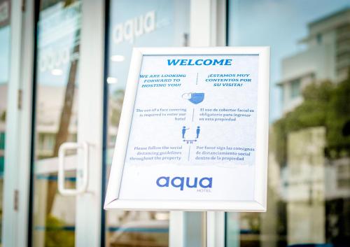 a welcome sign in front of a store window at Aqua Hotel & Suites in Miami Beach