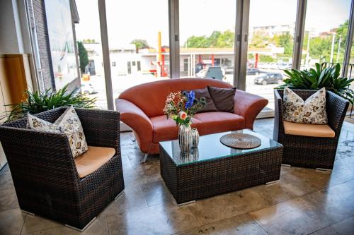 a living room with a couch and chairs and a table at Hotel Zur Aue in Wesel