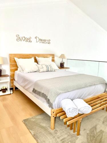 a bedroom with a large bed with towels on it at Casa Milheiras in Almeirim