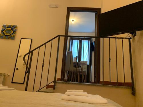 a room with a balcony with a bed and a mirror at Le Vie Mediterranee in Torre di Ruggiero