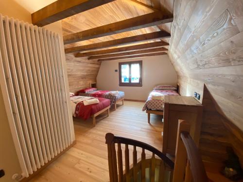 a attic room with two beds and a window at B&B Torri di Veglia in San Domenico