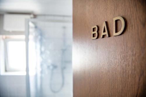 a door with a sign that says bad on it at Hotel Zur Aue in Wesel