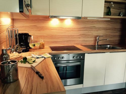 a kitchen with a stove and a sink at Das Ferienhaus in Attersee am Attersee