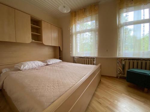 Кровать или кровати в номере Apartamentai Eurista
