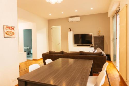 a living room with a couch and a table at Luxury Penthouse with Sea View - City Center in Pescara