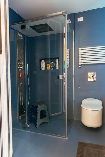 a bathroom with a glass shower with a toilet at Luxury Penthouse with Sea View - City Center in Pescara