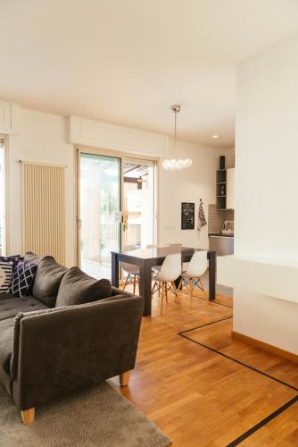 a living room with a couch and a table at Luxury Penthouse with Sea View - City Center in Pescara