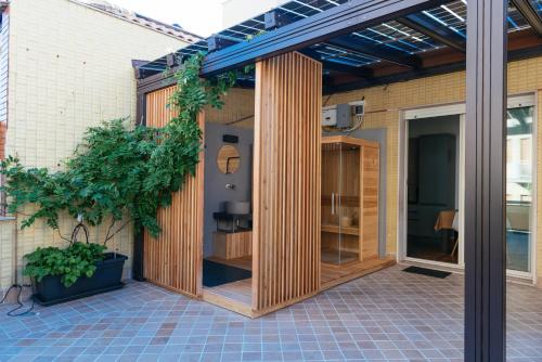 an extension to a house with wooden panels at Luxury Penthouse with Sea View - City Center in Pescara