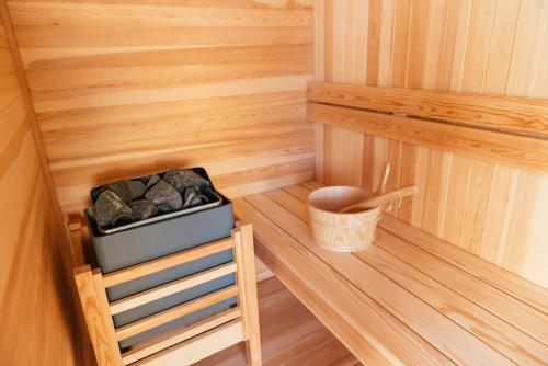 an inside view of a sauna with a bucket of rocks at Luxury Penthouse with Sea View - City Center in Pescara