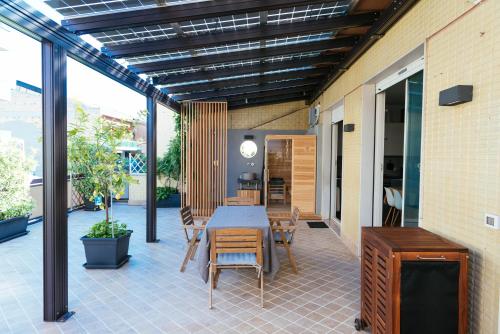 a patio with a table and chairs on it at Luxury Penthouse with Sea View - City Center in Pescara