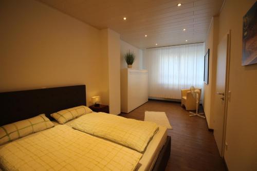 a bedroom with a yellow bed with two pillows at City Schloss Viktoria in Koblenz