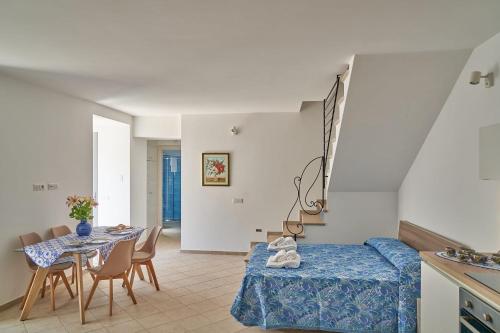 a room with a table and a bed and a dining room at Maiori Dream House 1 in Maiori