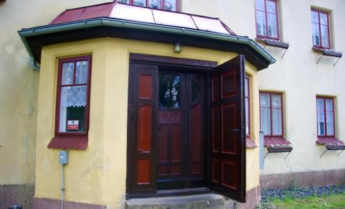a building with a red door and windows at Villa Sunshine / Slunečna Vila in Krásná Lípa