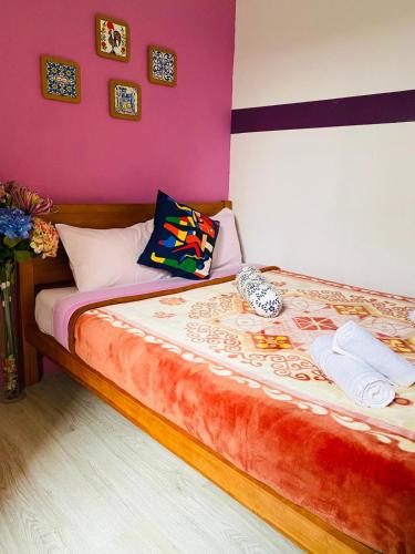 a bedroom with a large bed with purple walls at Lisbon Prime Hostel & Rooms in Lisbon