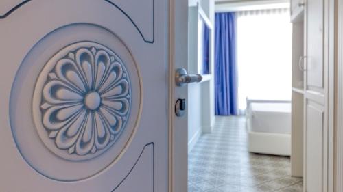 a bathroom with a door with a flower painted on it at Marmaris Beach Hotel in Marmaris