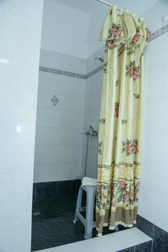 a bathroom with a shower with a shower curtain at Melina's Sunset in Myrties