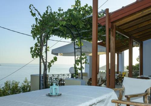 a table with a white table cloth on top of a house at Melina's Sunset in Myrties
