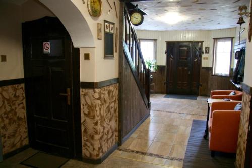 a hallway of a restaurant with two doors and chairs at Villa Sunshine / Slunečna Vila in Krásná Lípa