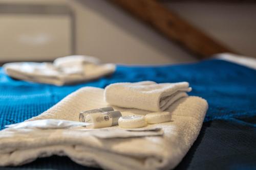 a pair of white towels sitting on top of a bed at Old Town Square Suites Prague in Prague