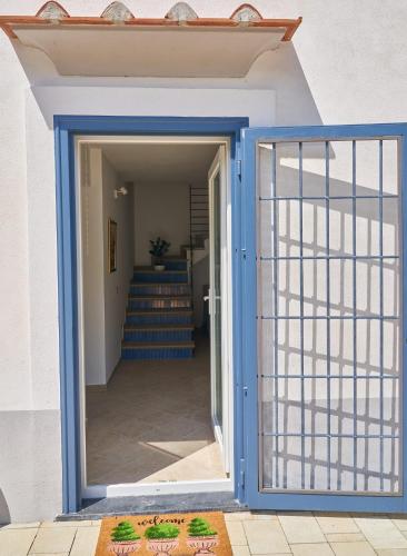 an open door leading to a stairway with blue trim at Maiori Dream House 1 in Maiori