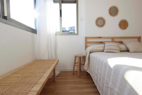 a bedroom with a bed and two mirrors on the wall at Can Lou-Casa con Caracter en Cullera in Faro de Cullera