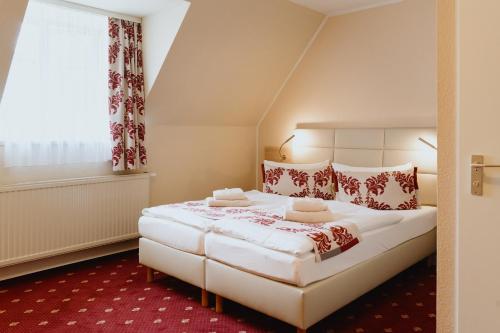 A bed or beds in a room at Hotel An den Bleichen