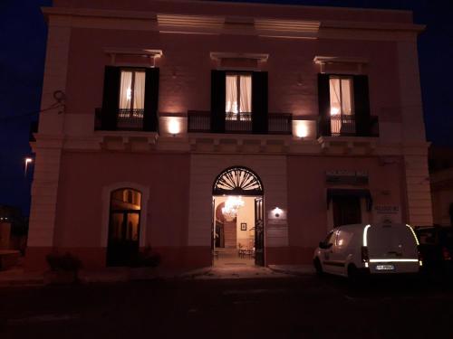a building with a car parked in front of it at night at Antico Palazzo Spinola in Gallipoli