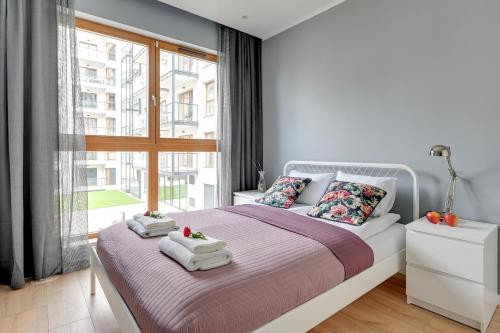 Ένα ή περισσότερα κρεβάτια σε δωμάτιο στο Maximus Apartment by TriApart