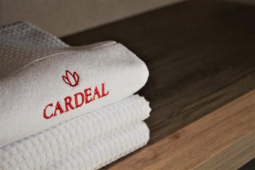 a stack of towels with the wordcard on them at Cardeal Suites & Apartments in Faro