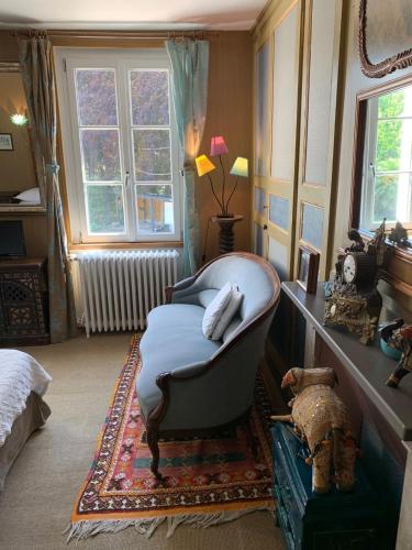 a room with a bed and a chair and a window at Chambres d'Hôtes Villa Mon Repos in Saint-Aubin-sur-Scie