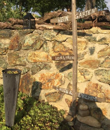 a stone wall with street signs on it at Ferienhaus Perwolff in Eisenberg an der Pinka