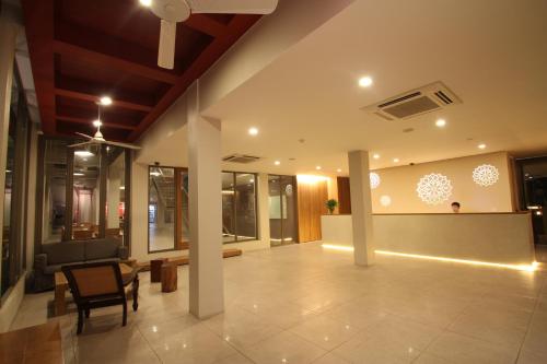 a lobby with a table and chairs in a building at CHERN Bangkok in Bangkok