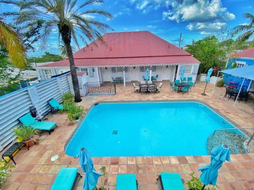 an image of a swimming pool in front of a house at Sugar Apple Bed and Breakfast in Christiansted