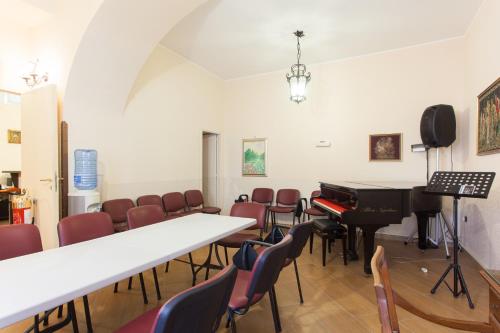 a room with a piano and some chairs at Hotel Toledo in Naples