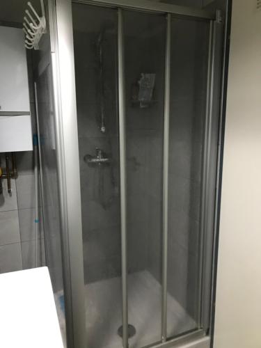 a shower with a glass door in a bathroom at Hava apartment in Sarajevo