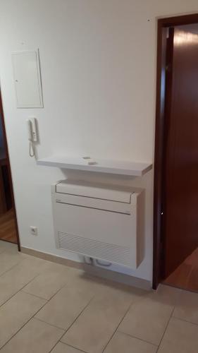a white wall with two drawers in a room at Ferienwohnung "SCHÖNBUCH" , Pension Wauri in Waldenbuch