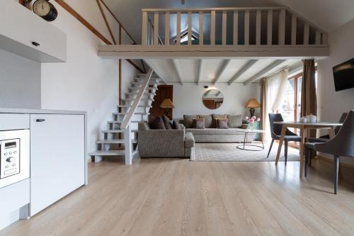 a living room with a couch and a staircase at Rasos Vila in Palanga